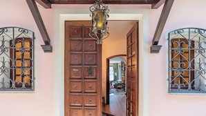 Uma porta de madeira com vários painéis pequenos e um portão metálico de cada lado.