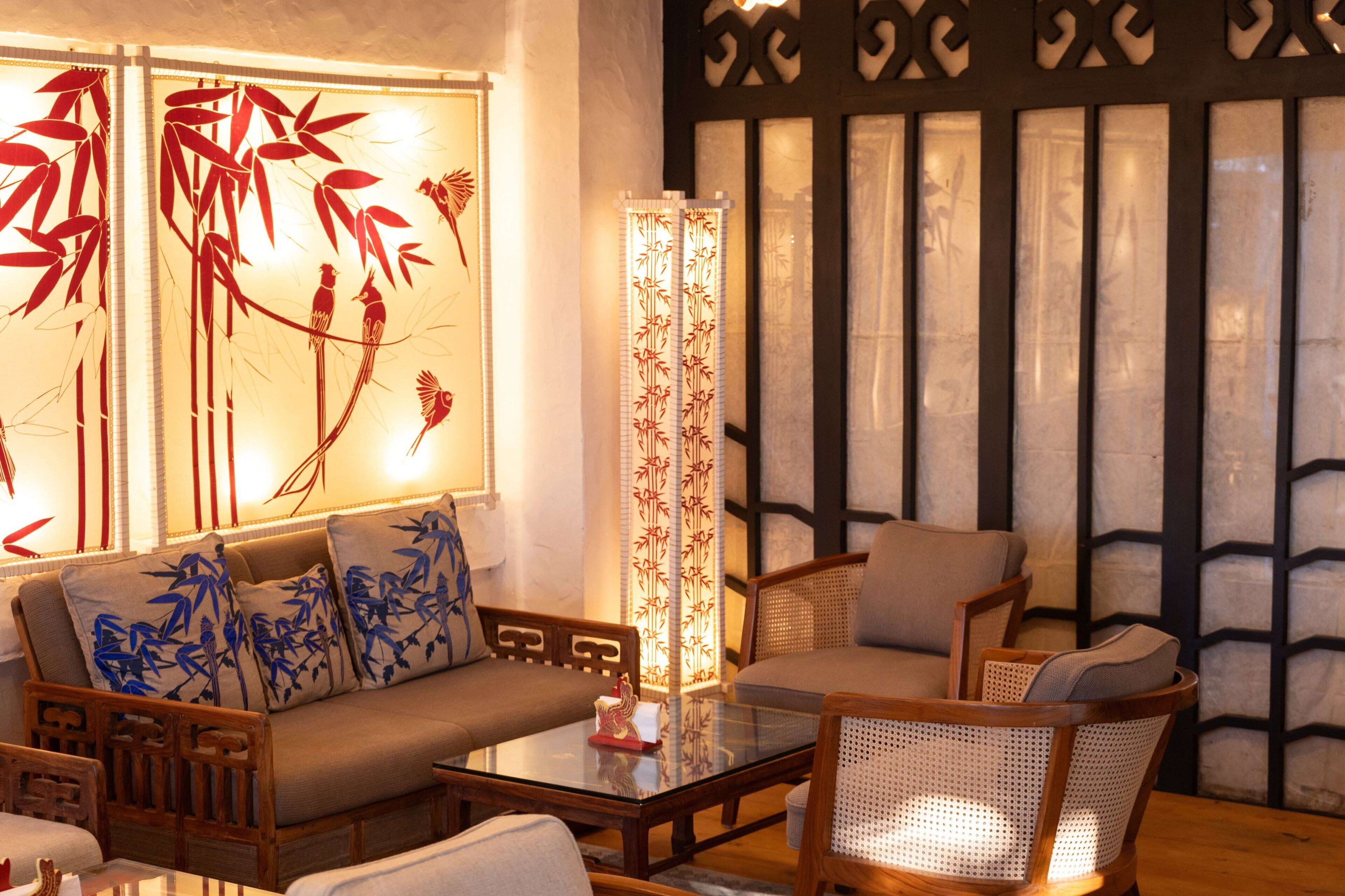 A traditional-style room with a sofa, chairs, and a glass coffee table.