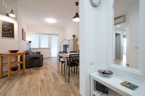 A modern apartment with a living area, dining space, and a kitchen.