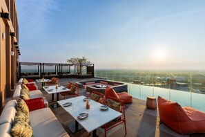A rooftop terrace with outdoor seating, a fire pit, and a panoramic city view. - Centara Ayutthaya (Ayutthaya)