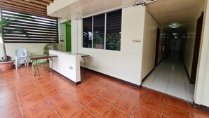 A reception area with a desk, chairs, and a 'No Smoking' sign. - Goland Pension House and Dormitory by SMS Hospitality (Cebu City)