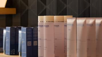 A shelf with various skincare products, including bottles and boxes, arranged in an orderly fashion.