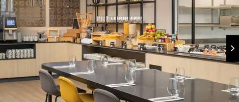 A modern dining area with a long table set for six, surrounded by yellow chairs.