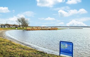 Enjoy a serene lakeside retreat with a clear view of the water and surrounding landscape.