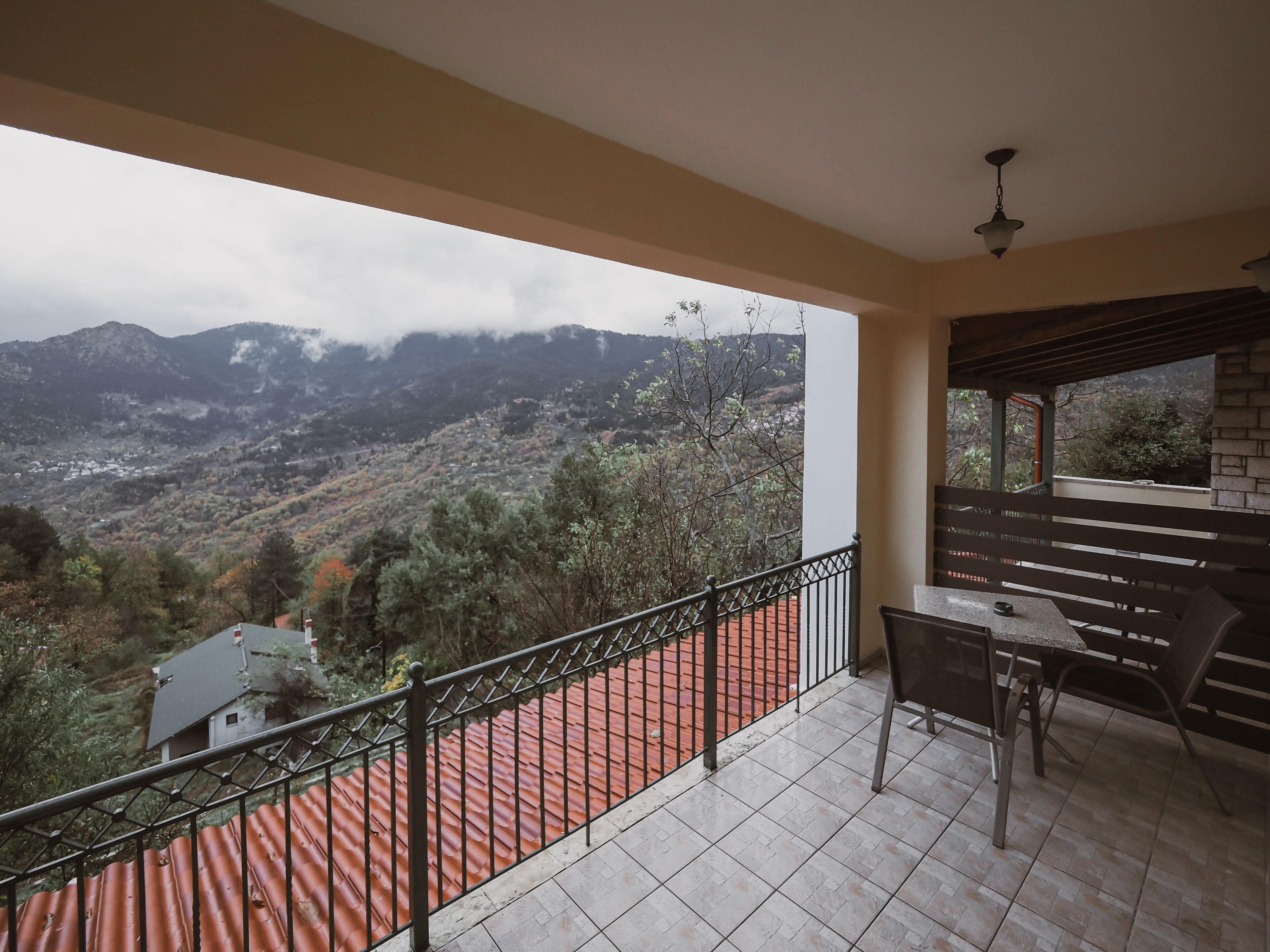 A balcony with a view of a mountainous landscape.