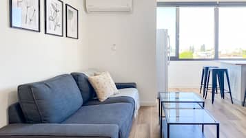 Luxury Apartment | Living area | 43-inch flat-screen TV with cable channels