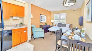 A compact room with a kitchenette, a dining area, and a bed. - Condo Close to Universal Studios w/ Pool & Hot Tub (Orlando)