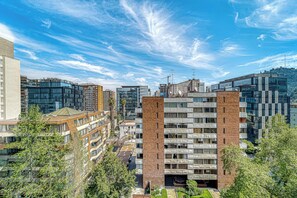 Ein modernes Stadtgebäude mit mehreren Etagen, großen Fenstern und einer Fassade aus Backstein und Glas.