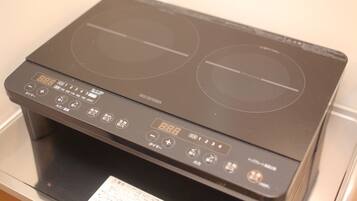An electric stove with a digital display and multiple control buttons.