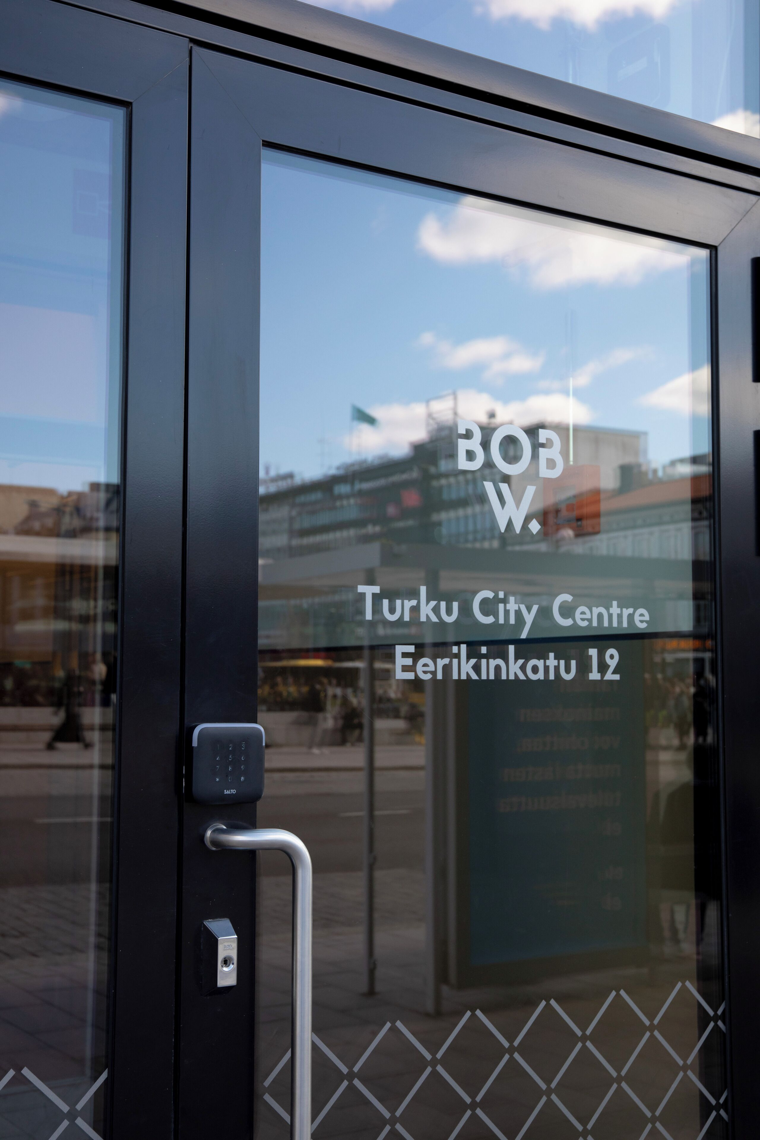 Una porta de vidre amb un cartell que diu "Bob W. Turku City Centre Eerikinkatu 12".