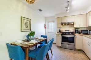 A compact kitchen with a built-in oven, microwave, and coffee maker. - Barefoot Mermaid 1, steps to the beach (Anna Maria)
