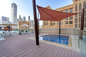Relax on the rooftop terrace with a pool, sun loungers, and umbrellas, offering a serene escape amidst the city's modern skyline.