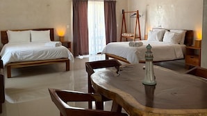 A hotel room with two beds, a dining table, and a ceiling fan. - Mexhe Hotel Boutique (El Cuyo)
