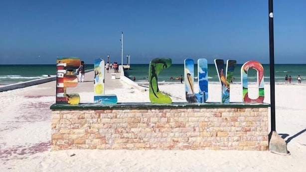 A beach sign with colorful letters spelling 'LOVE' and a street lamp. - Mexhe Hotel Boutique (El Cuyo)