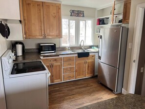 Fridge, microwave, oven, stovetop - Cozy Tree-Area Home in Laramie (Laramie)