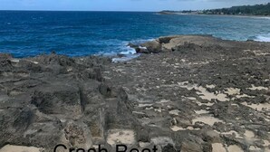 A rocky shoreline with the ocean in the background. - Experience Puerto Rico's Charm in style with modern comforts.  (Luyando)