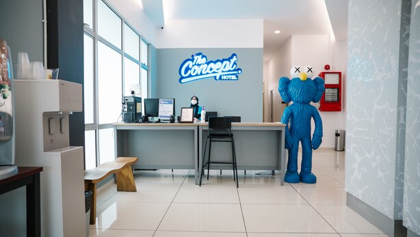 A hotel reception area with a large blue mascot, a reception desk, and a sign reading "The Concept Hotel". - The Concept Hotel Melaka City (Malacca City)