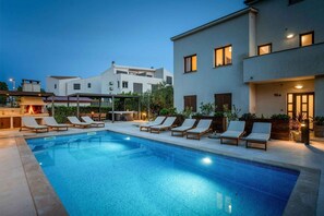 Relax by the pool surrounded by comfortable lounge chairs and enjoy the serene atmosphere.