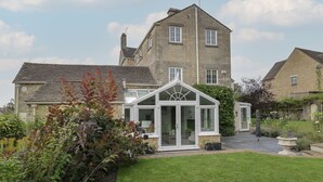 A two-story stone house with a conservatory. - The Gate House (Cirencester)
