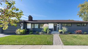 A modern two-story house with a brick exterior, large windows, and a well-maintained lawn. - Casa 22 Luxury & Modern 3BD 2BA Home in Skokie (Skokie)