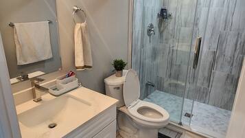 Shower, towels, soap, toilet paper