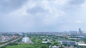 A cityscape with a mix of residential and commercial buildings, a large green park area, and a body of water. - Good Deal And Cozy Stay Studio Room Tifolia Apartment (Jakarta)