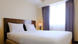 A neatly made bed with white linens in a hotel room. - Strategic And Comfortable 2Br At Braga City Walk Apertment (Bandung)