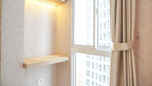 A room with a window, a light fixture, and a curtain. - Homey And Well Furnished Studio Tokyo Riverside Pik 2 Apartment (Teluknaga)