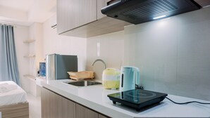 A modern kitchen with a built-in stove, a sink, and a countertop.