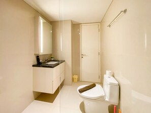 A modern bathroom with a sink, mirror, toilet, and a towel rack. - Best Deal And Strategic 2Br Marquis De Lafayette Apartment (Semarang)