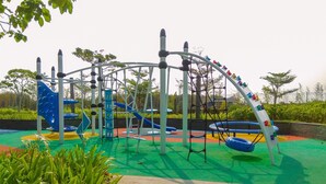 A playground with various play structures including slides and climbing frames. - Homey And Warm Studio At 28Th Floor Gold Coast Apartment (Jakarta)