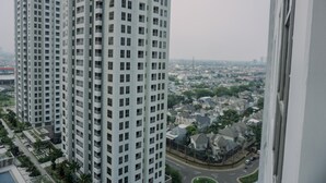 A high-rise building with a view of a residential area below. - Good Choice 2Br Apartment M-Town Residence (Gading Serpong)