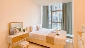 A modern bedroom with a large bed, a bedside table with a mirror, and a dresser. - Comfort Stay 2Br At L'Avenue Pancoran Apartment (Jakarta)