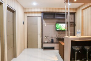 Relax in a stylish space with a flat-screen TV, desk area, and seating nook.