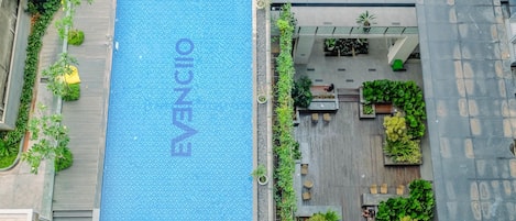 A rooftop pool with a clear view of the surrounding buildings and greenery.