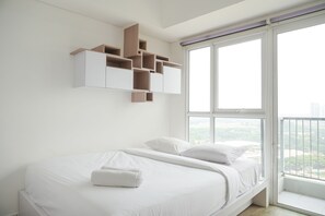 Enjoy a restful stay in this stylish room with a large bed, shelving unit, and city view.