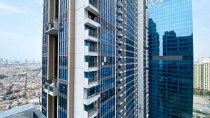 A high-rise building with multiple balconies and a modern architectural design. - Best Spacious And Nice 3Br At 28Th Floor Casa Grande Apartment (Jakarta)