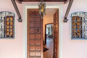 A wooden door with multiple small panels, a wrought iron gate, and a hanging light fixture. - Il Tentione, Valsolda, Italy (Valsolda)