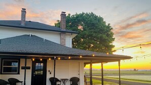 A house with a covered porch, outdoor seating, and a view of the landscape. - Updated Farmhouse with lots of outdoor space and beautiful views! (Linn County)
