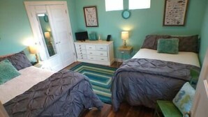 A room with two beds, a dresser, a desk, and a small stool. - Great Escape -2 Br 2Ba Waterfront Bay St Louis MS (Hancock County)