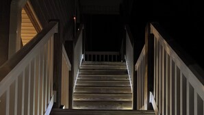 A wooden staircase with white railings, leading upwards. - Amazing views, short walk to the beach, Pup friendly home in Surf City, NC! (Surf City)