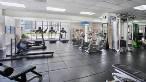 A gym with treadmills, elliptical machines, and weightlifting equipment. - Spacious Beachfront Retreat,
Family Friendly,
Free parking/Free Public Trolley (Miami Beach)