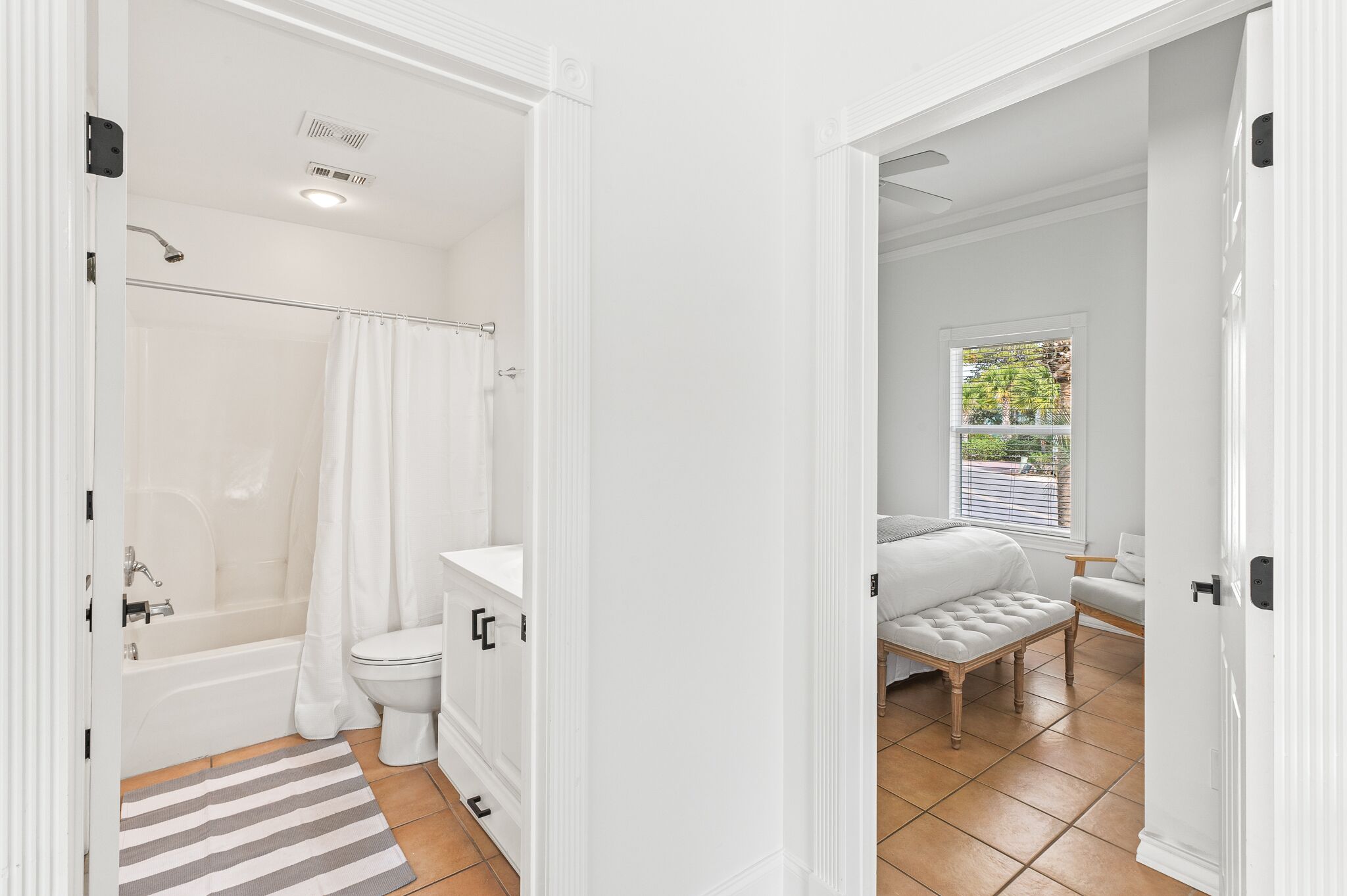 A bathroom with a bathtub, toilet, and shower curtain.