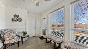 A covered porch with a ceiling fan, a bench, a chair, and a small table with a plant. - 5 minutes from strip|Pool|King|Stainless|300Mbps|4K|WD|BBQ (Branson)