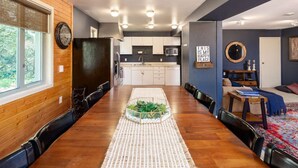 A modern kitchen with white cabinets, a microwave, and a sink.