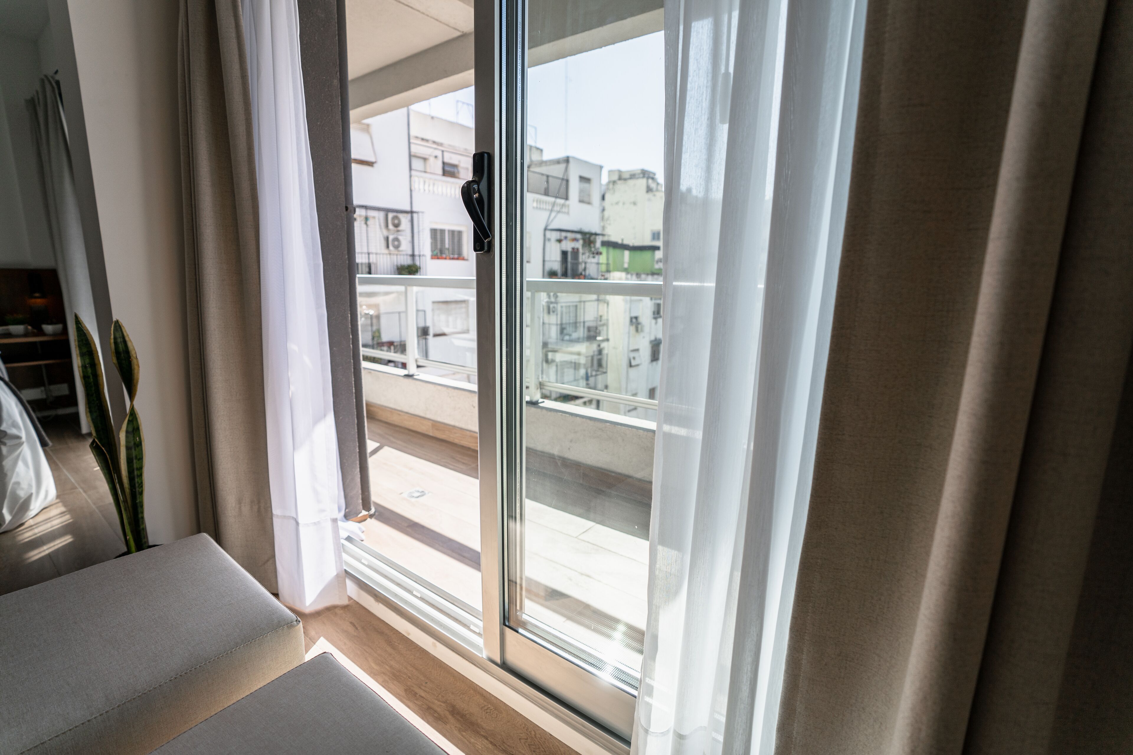 A room with a sliding glass door leading to an outdoor balcony.