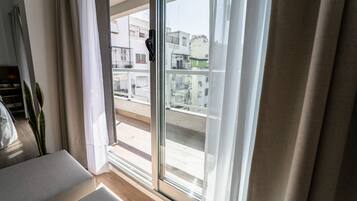 A room with a sliding glass door leading to an outdoor balcony.
