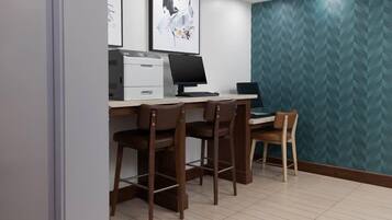A workspace with a desk, two chairs, a computer, and a printer.
