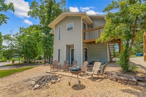 A two-story house with a covered porch, outdoor seating, and a barbecue grill. - Tranquil Woods Retreat Branson (Branson)