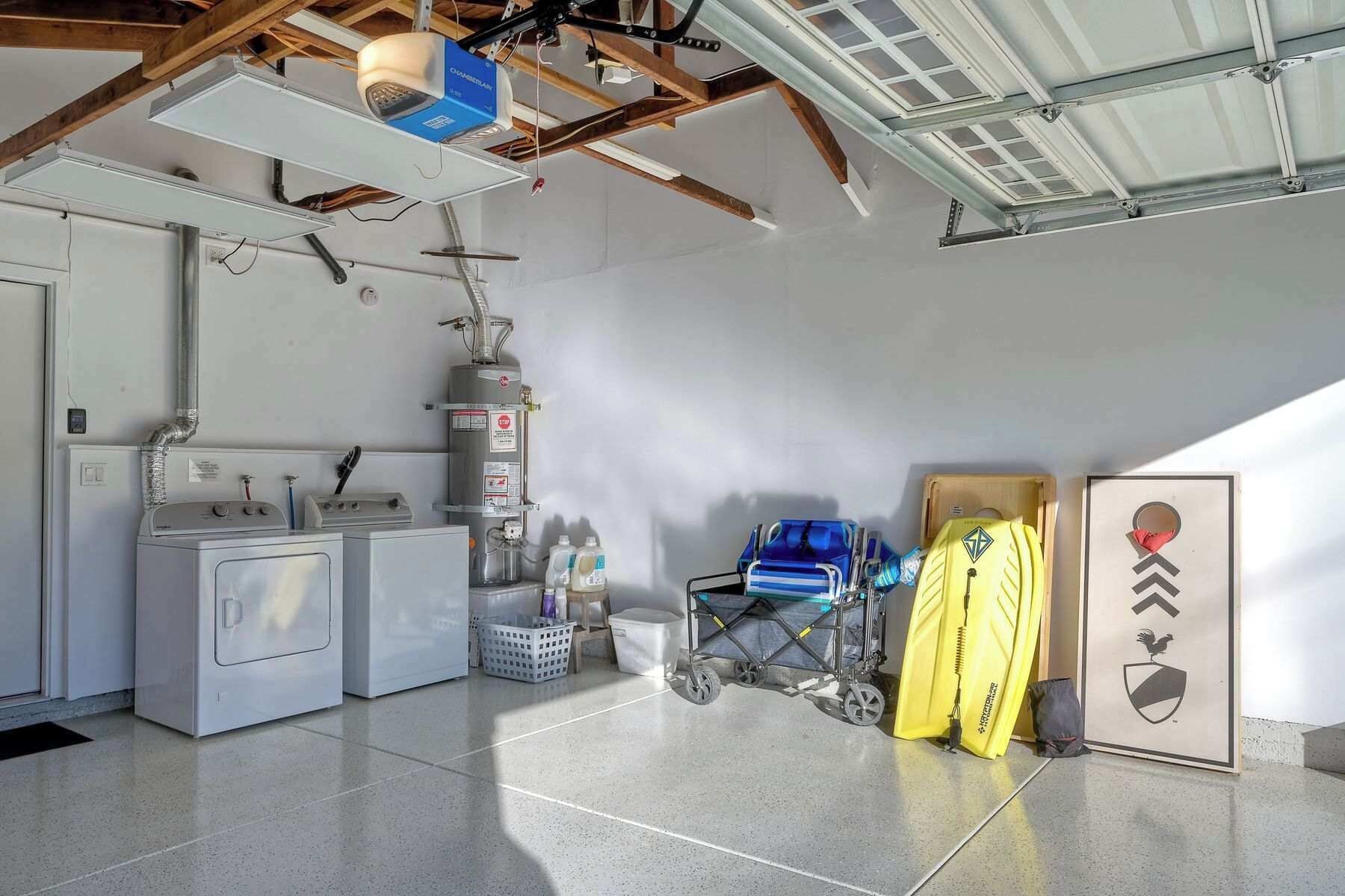 A laundry room with a washing machine, dryer, and stacked laundry baskets.